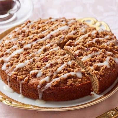 Hummingbird Cake on a platter served with coffee on the side.