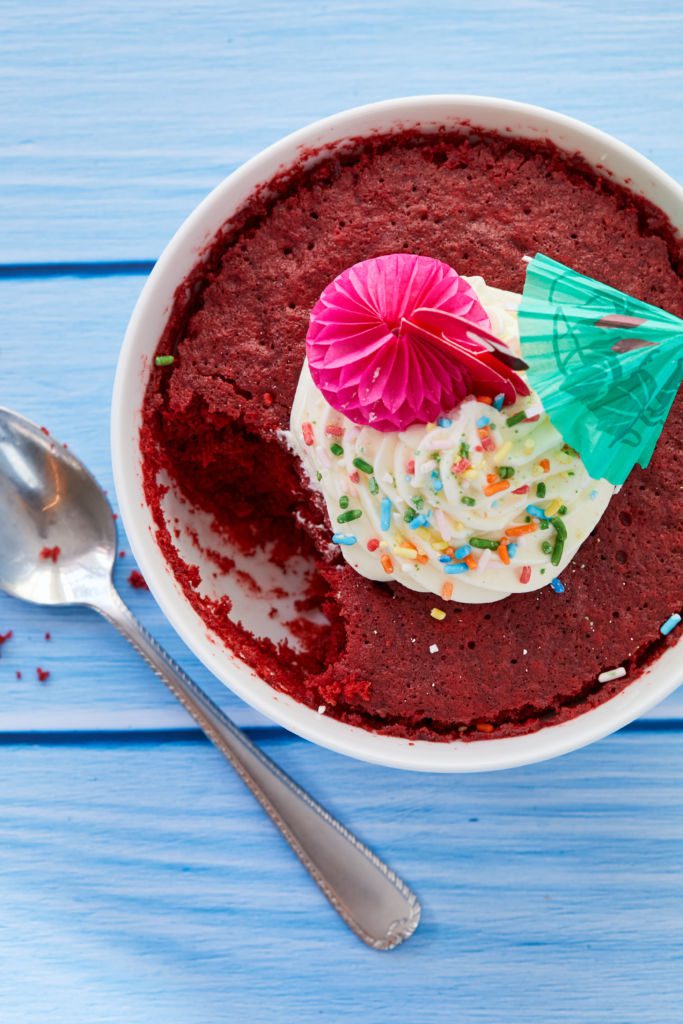 A red velvet cake bowl with a bite taken out of it