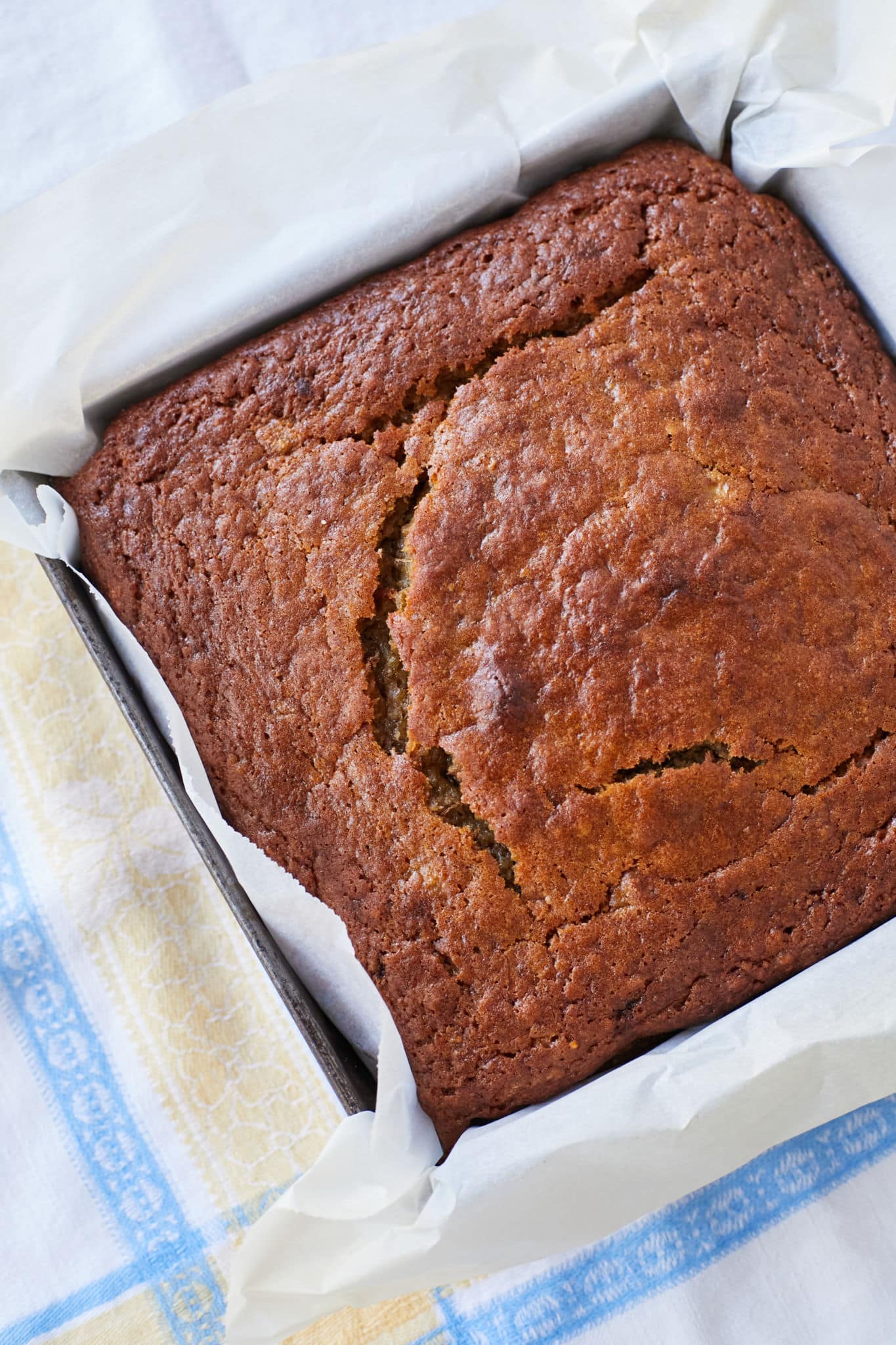 A loaf of moist sourdough banana bread is pictured from above.