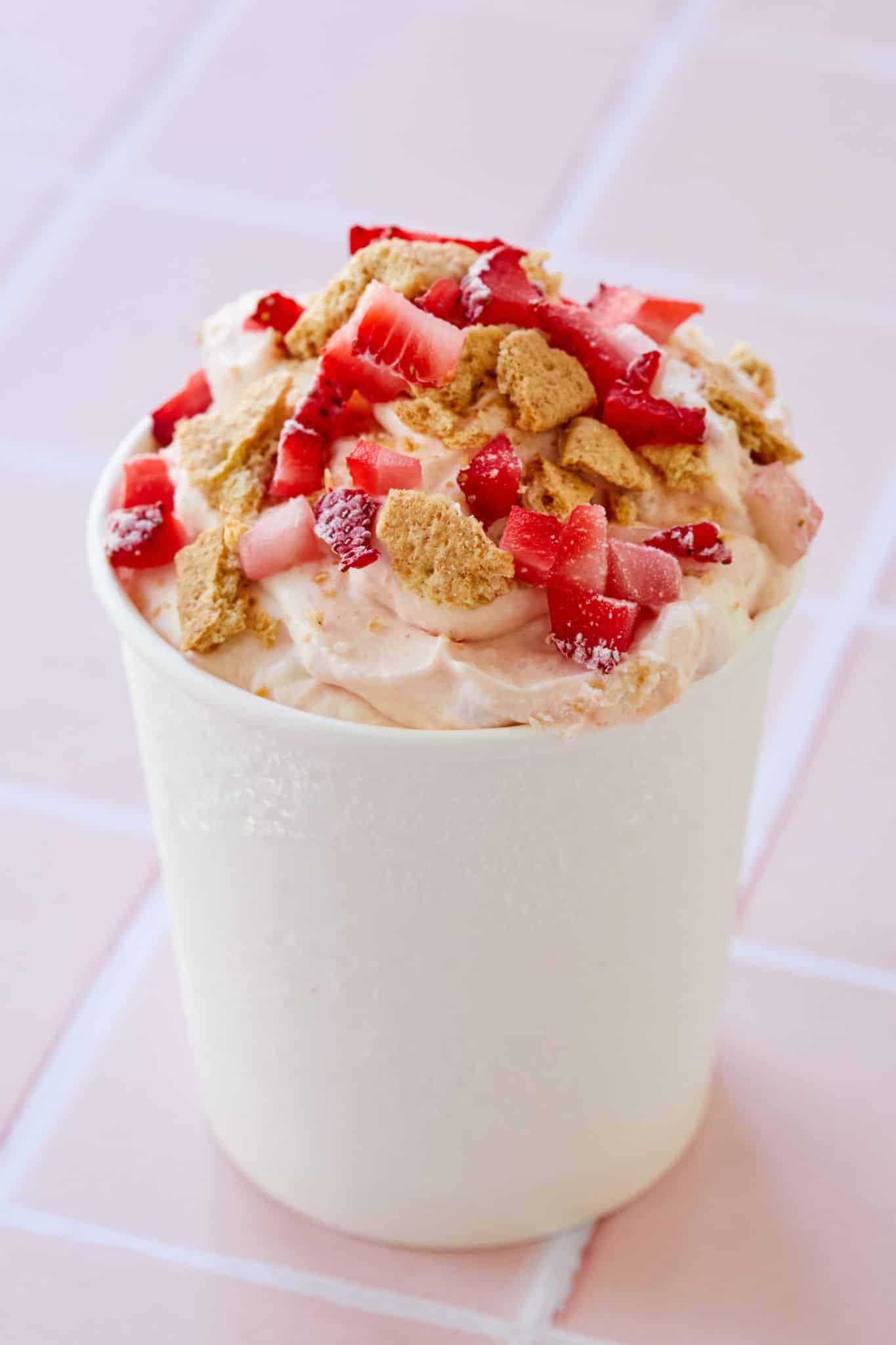 A tub of strawberry cheesecake ice cream