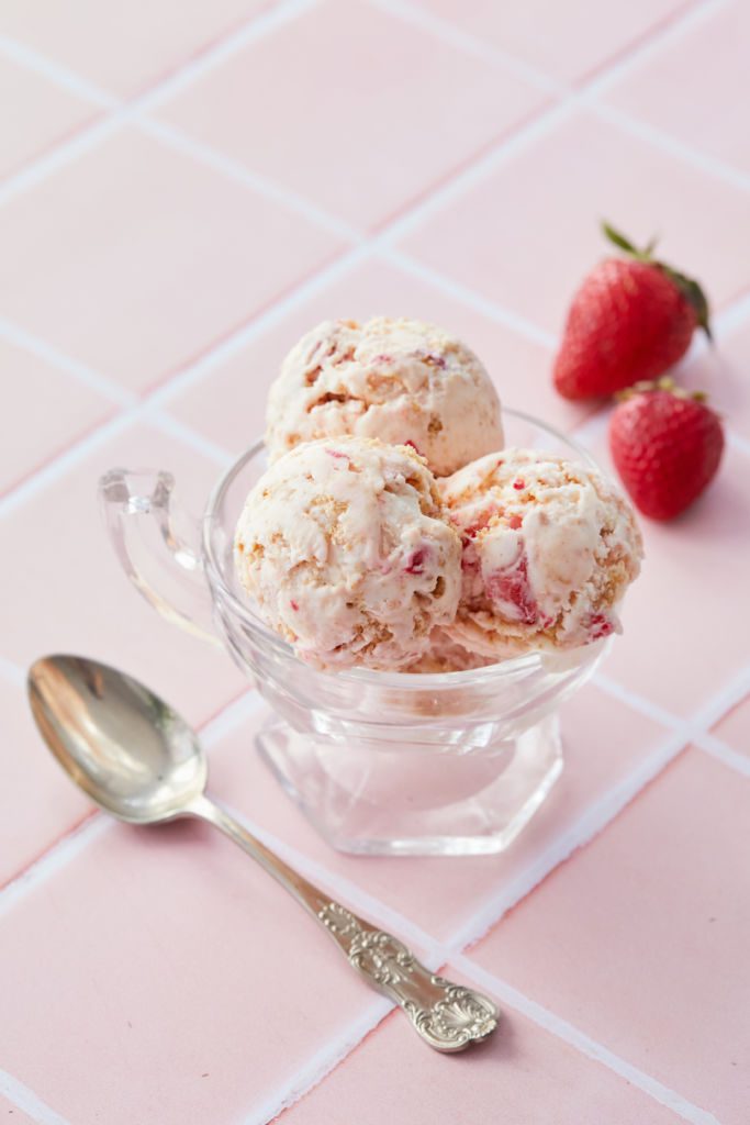 A dish of ice cream with strawberries