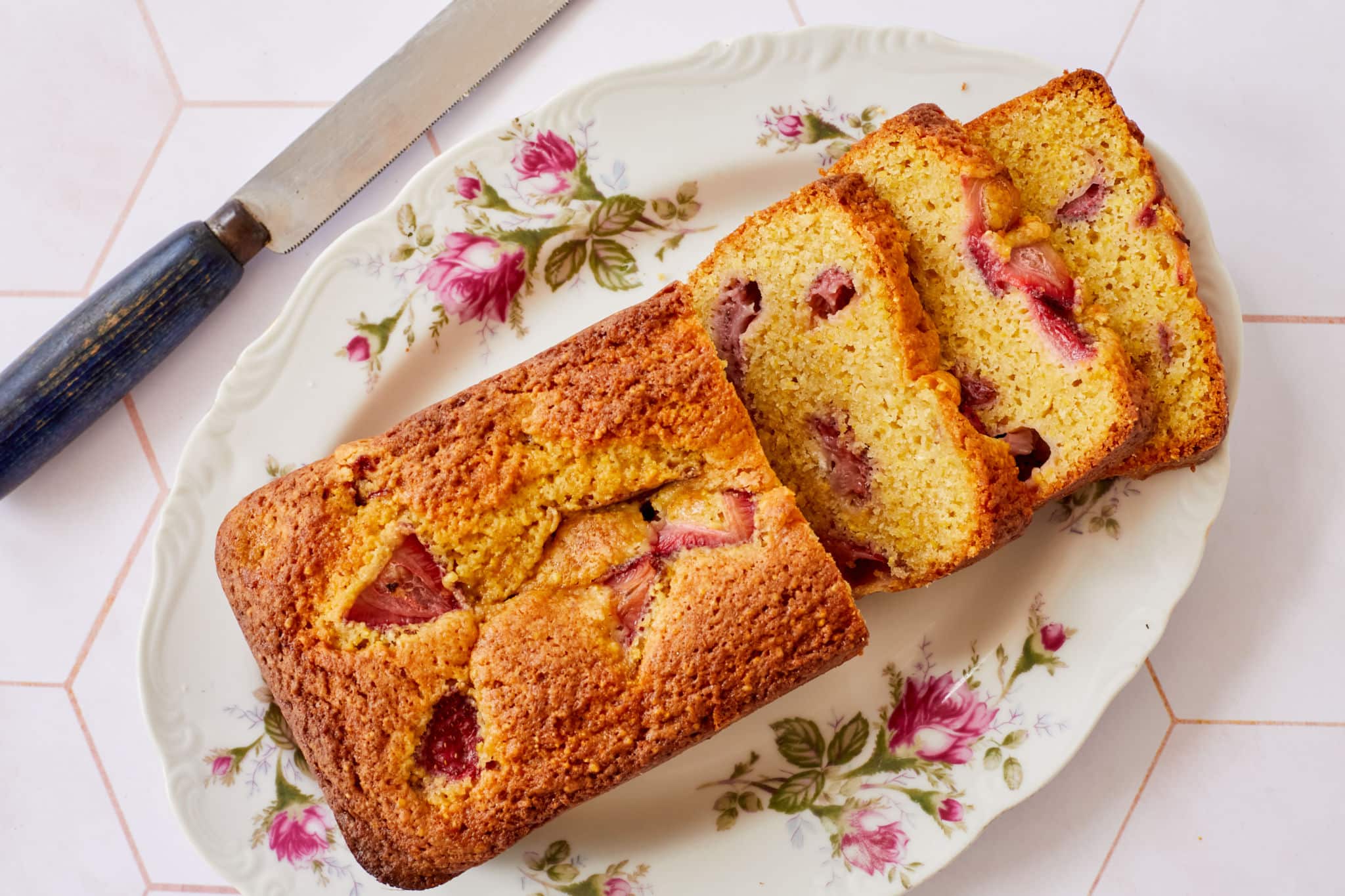 Strawberry Cornmeal Quick Bread sliced on a plate