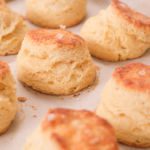 A bunch of buttermilk biscuits on a baking tray