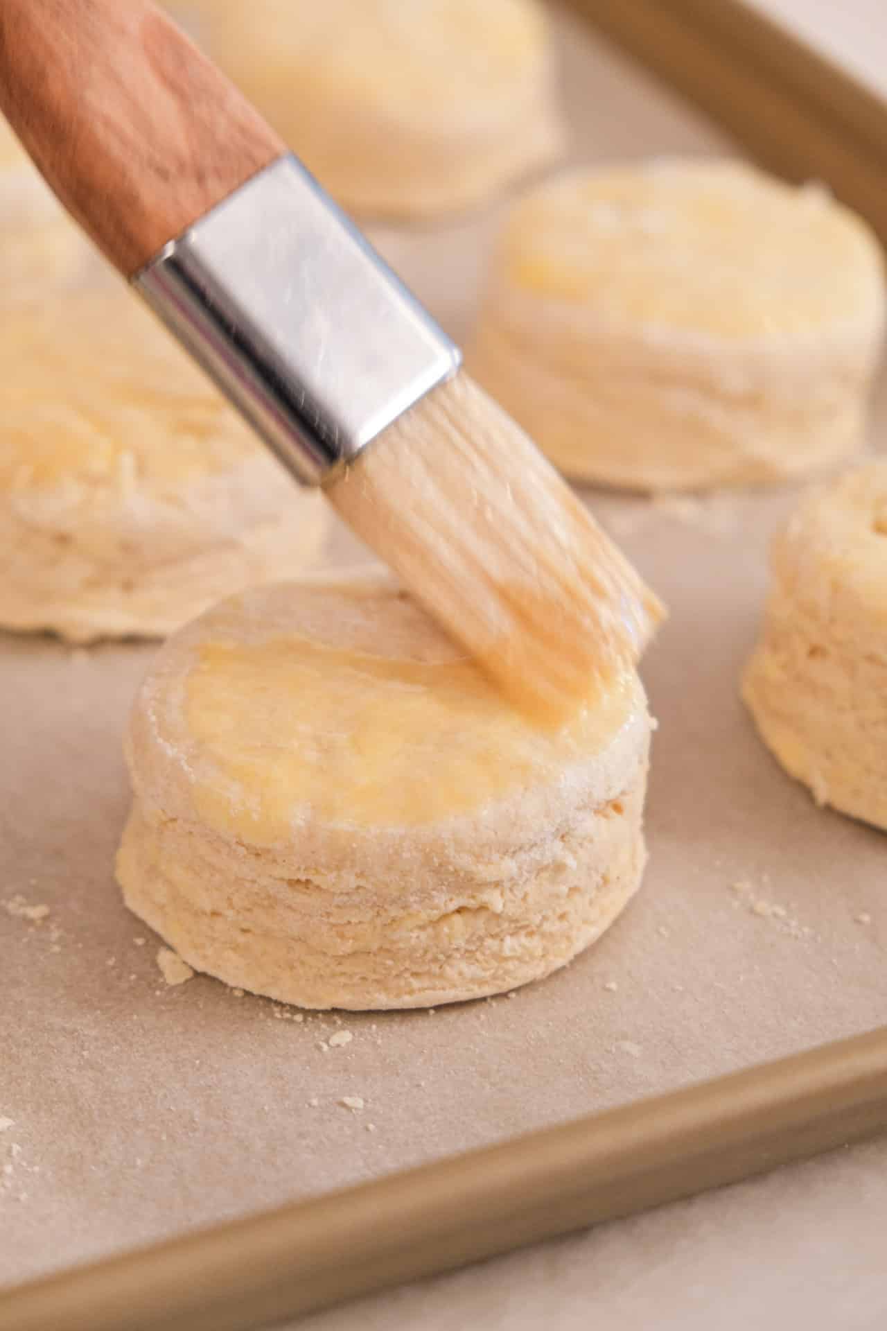 Brushing the top of buttermilk biscuits