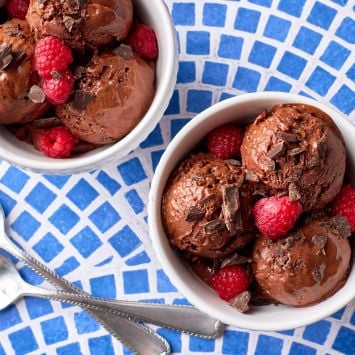 Healthy banana chocolate ice Crean is served with raspberries and chocolate chunks.