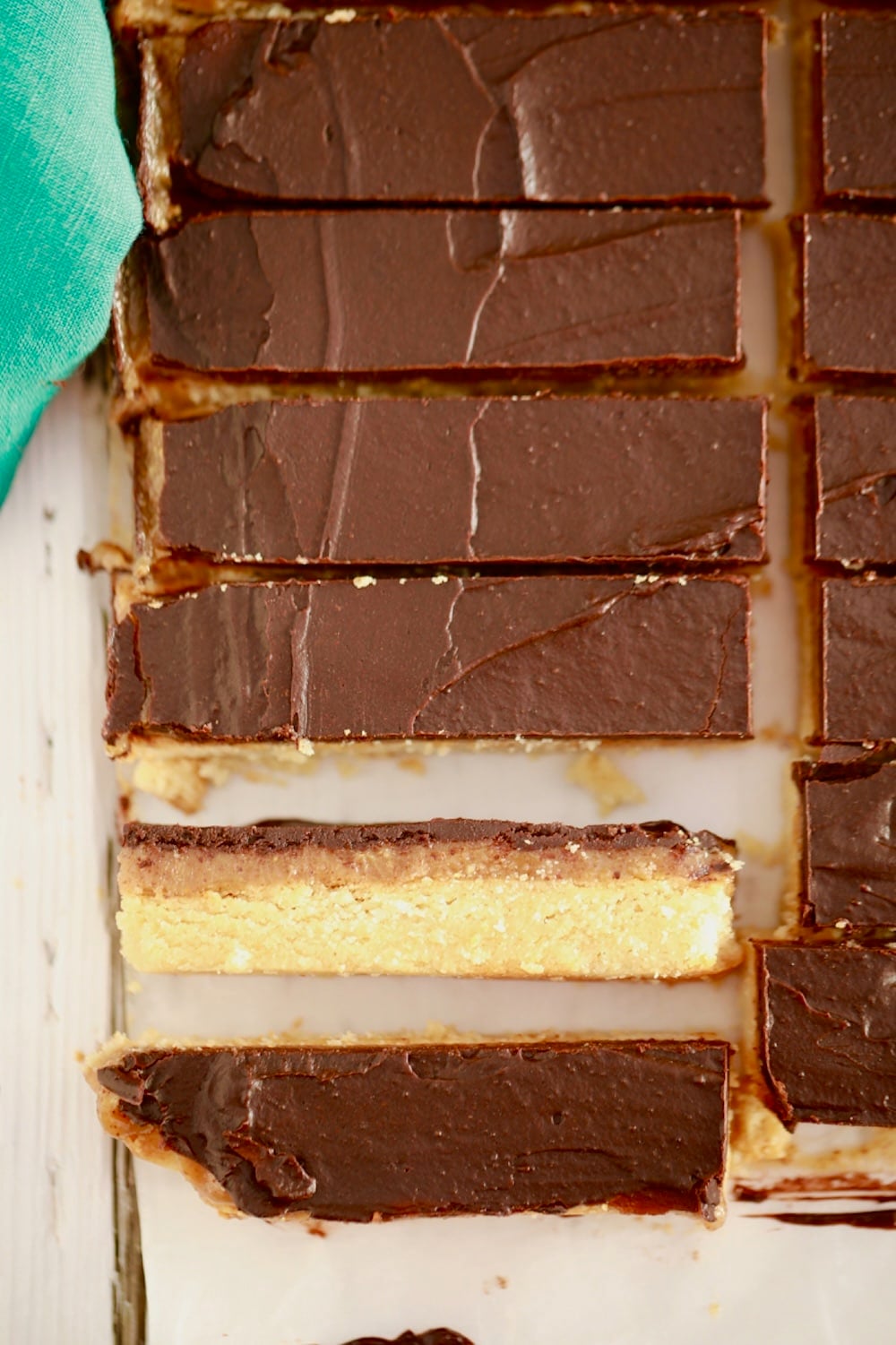 Homemade Twix Top-down view of Twix bars with chocolate, caramel layer and shortbread bottom.