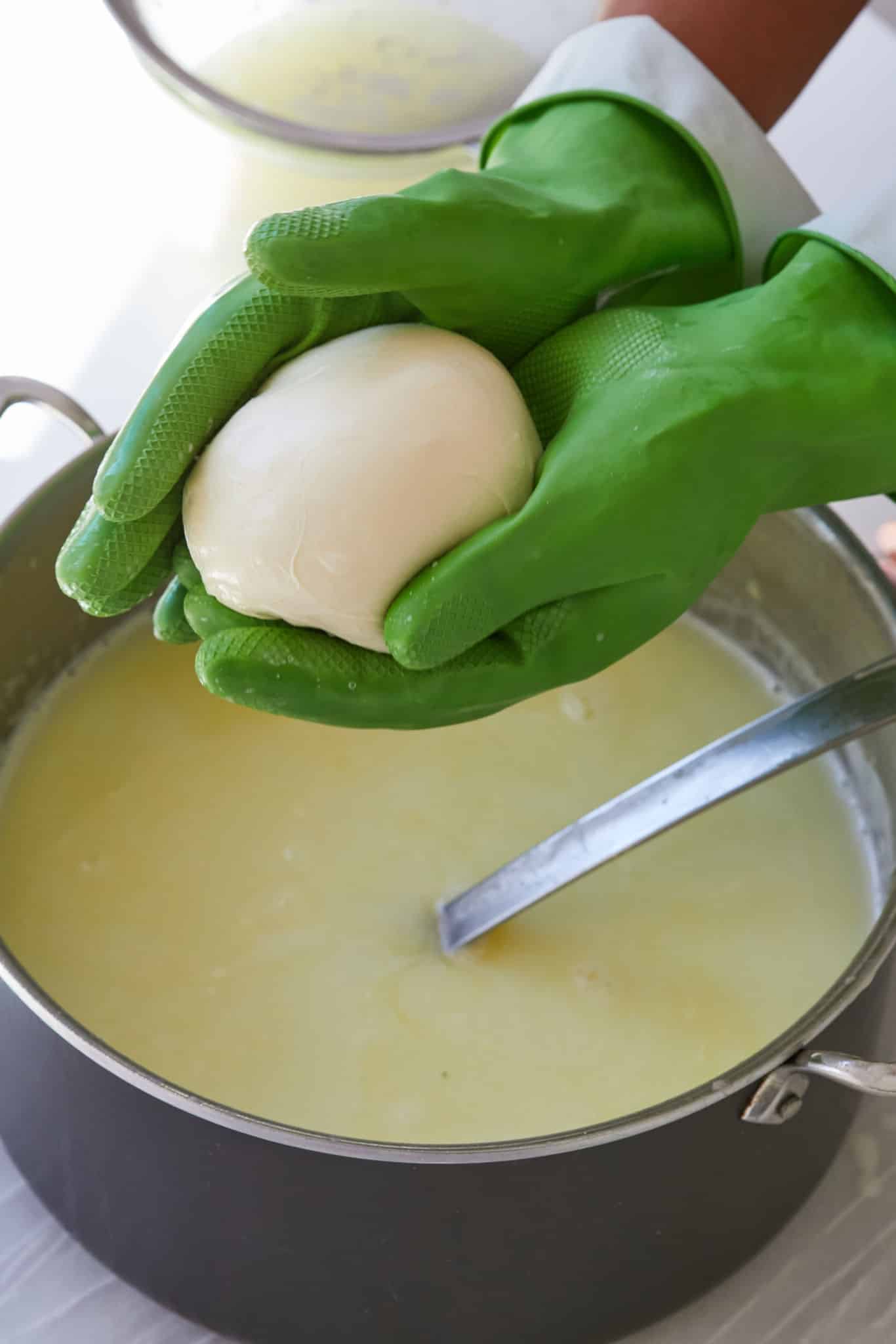 Shaping Homemade Mozzarella: create a smooth ball, tucking the edges underneath