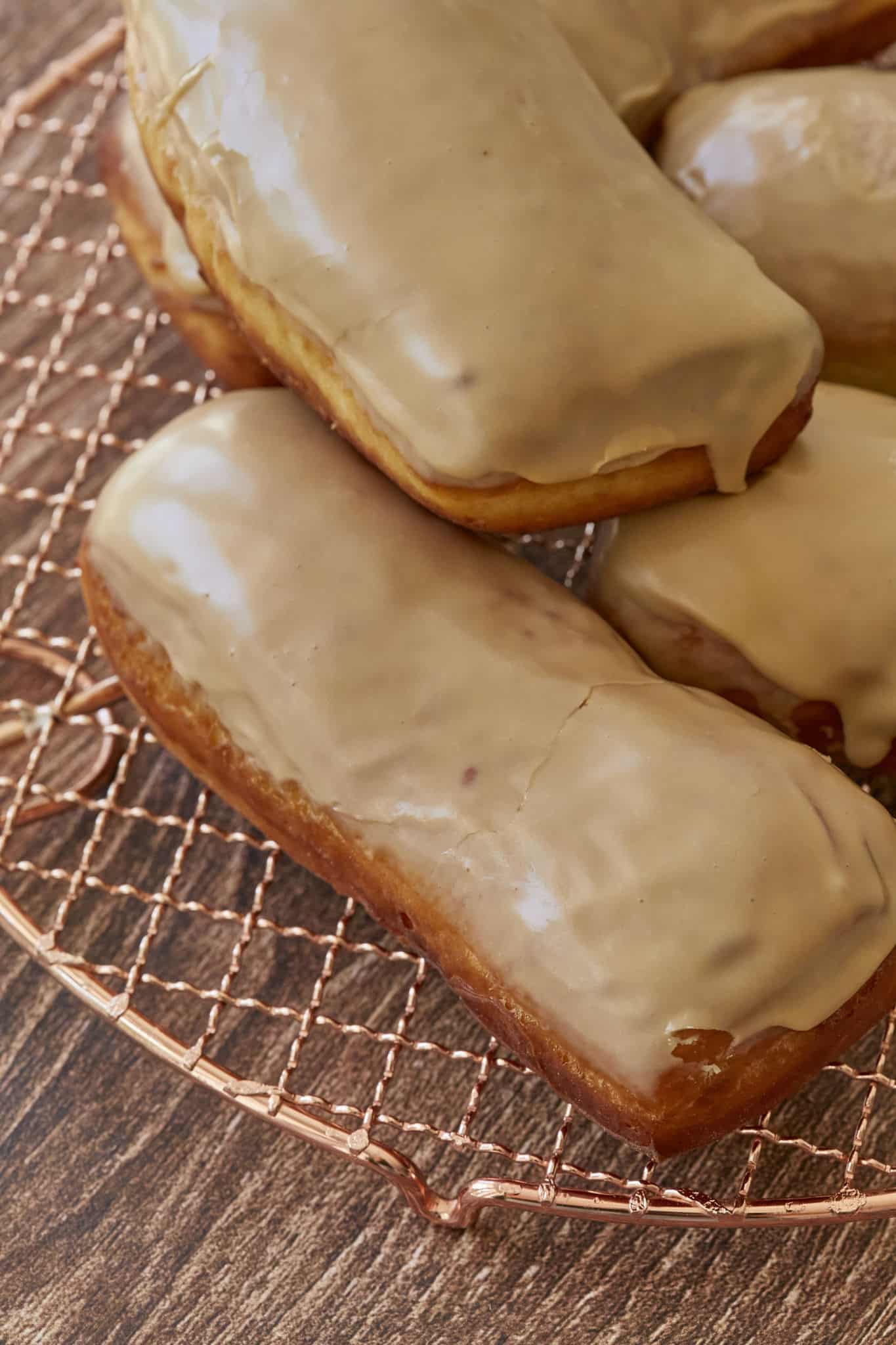 A closeup of the homemade maple bar donuts show the thick maple glaze on top of a chewy donut.
