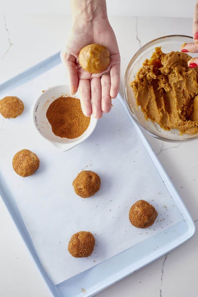 Chewy Maple Pumpkin Cookie dough is rolled in a cinnamon mixture before baking.