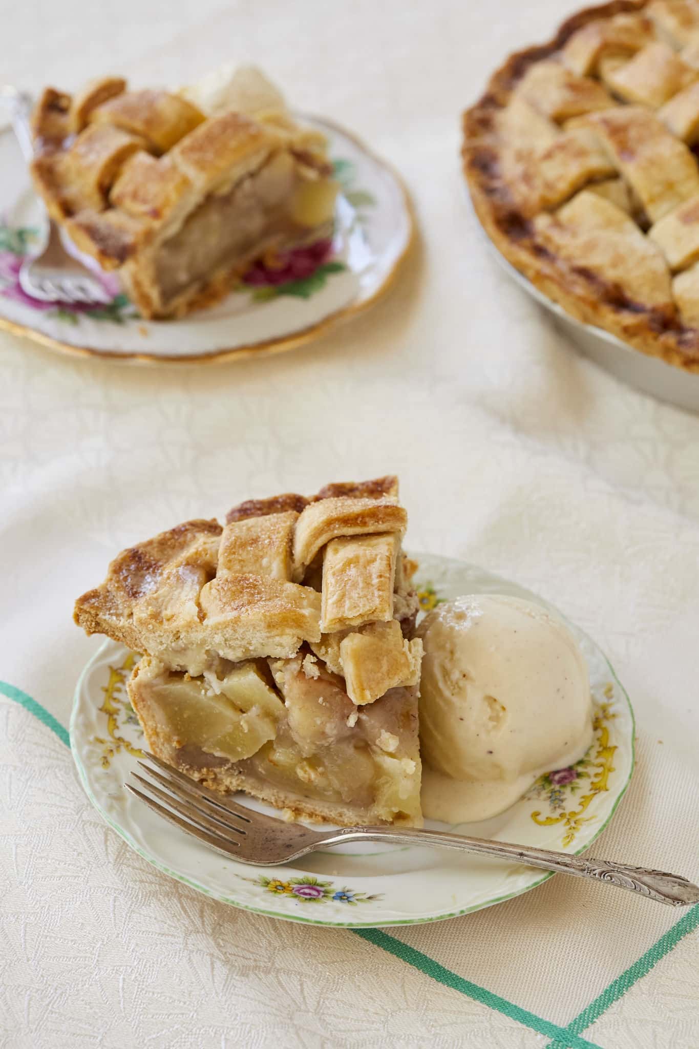 A closeup image of pear pie shows chunks of peeled pear spiced with cinnamon and nutmeg. 