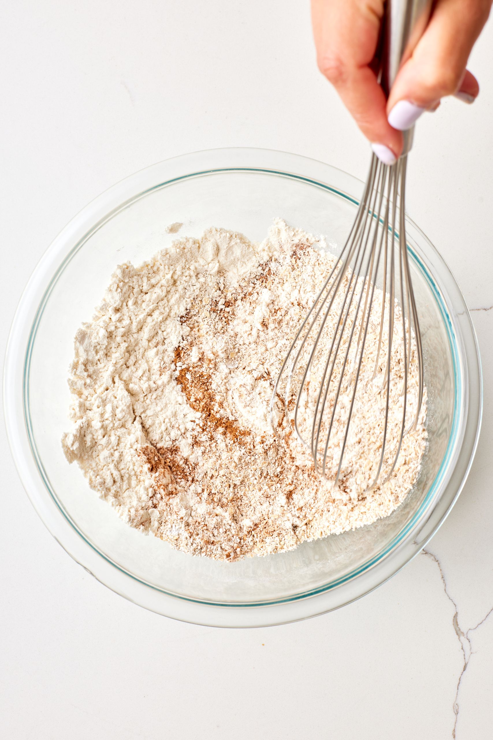 Step-by-step instructions on how to make Apple Coffee Cake: mix dry ingredients. 