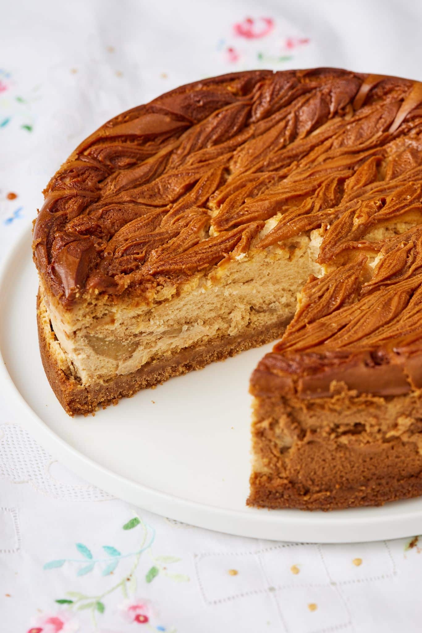 Caramel Apple Cheesecake18 Chill then slice -- a whole caramel apple cheesecake with one slice cut.