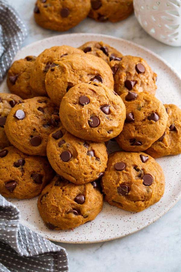 A plate of fluffy pumpkin chocolate chip cookies on a white plate.
