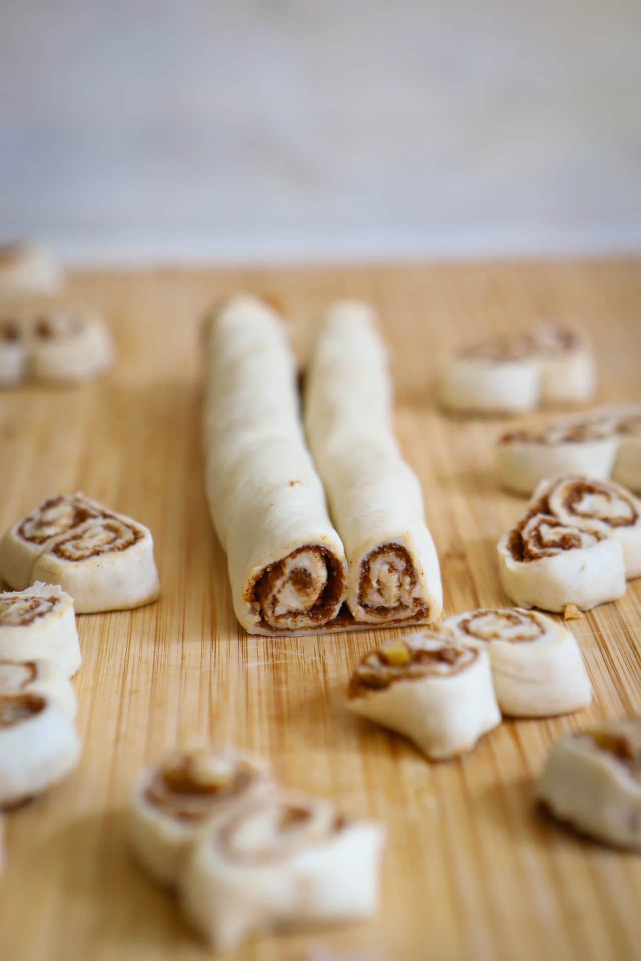 Cinnamon roll palmier dough rolled into a double roll, with a few palmiers cut off of the end of the roll.