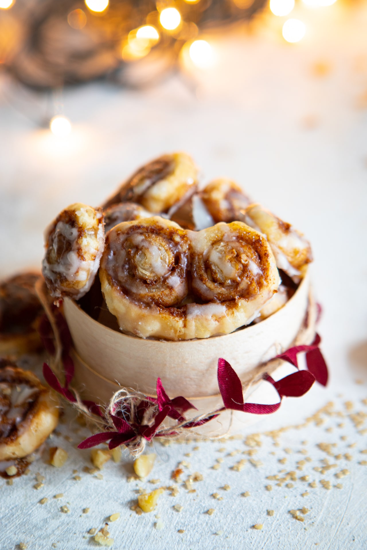 A tub of finished cinnamon roll palmiers with festive decorations. 
