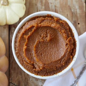 Homemade pumpkin butter is served in a white bowl.