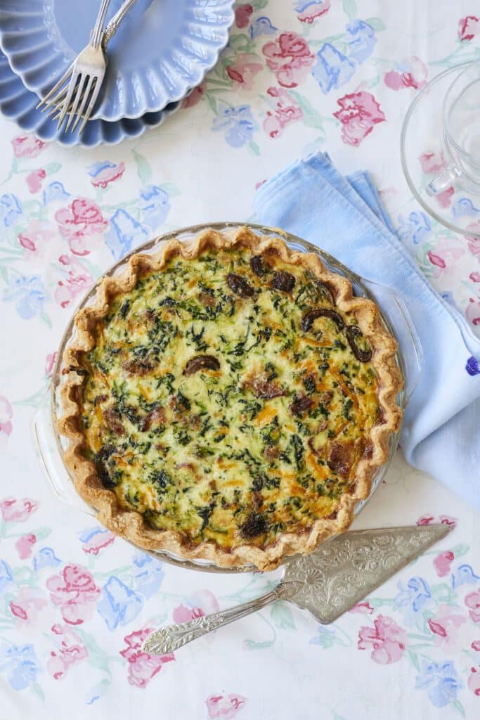 Homemade Quiche with golden brown buttermilk pie crust and rich soft custard filling loaded with spinach and mushroom.