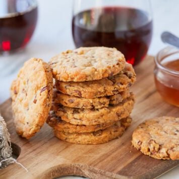 Savory, crispy, and crumbly cheesy cheddar and pecan shortbread cookies served with wine and honey.