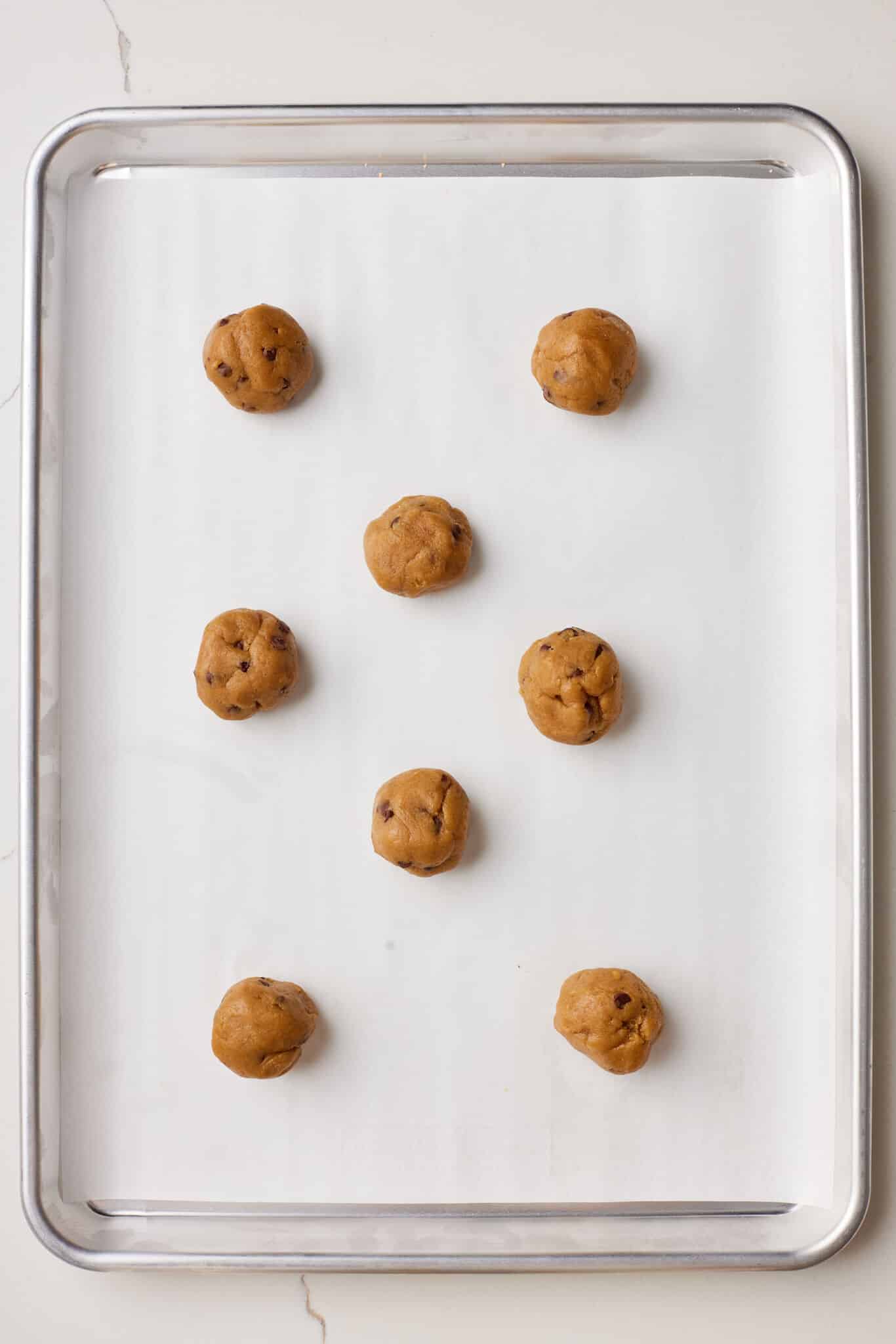 Roll 1 tablespoon-sized scoops of dough into balls, then flatten until the dough is ¼-inch (6mm) thick and place 2 inches (5 cm) apart on the prepared baking sheets.