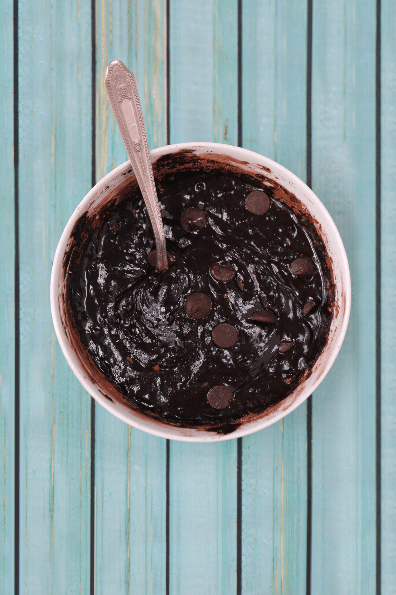 Brownie bowl batter is looking rich, thick and smooth. topped with chocolate chips, ready for cooking in the microwave. 