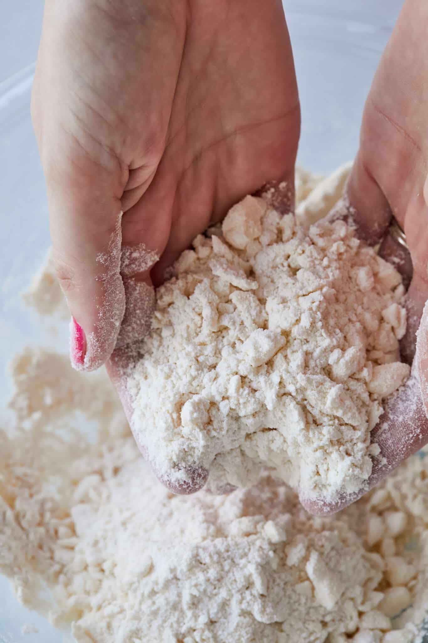 Step-by-sep instruction on how to make a flaky sour cream pie crust: rub cold butter into flour until the mixture resembles coarse bread crumb.