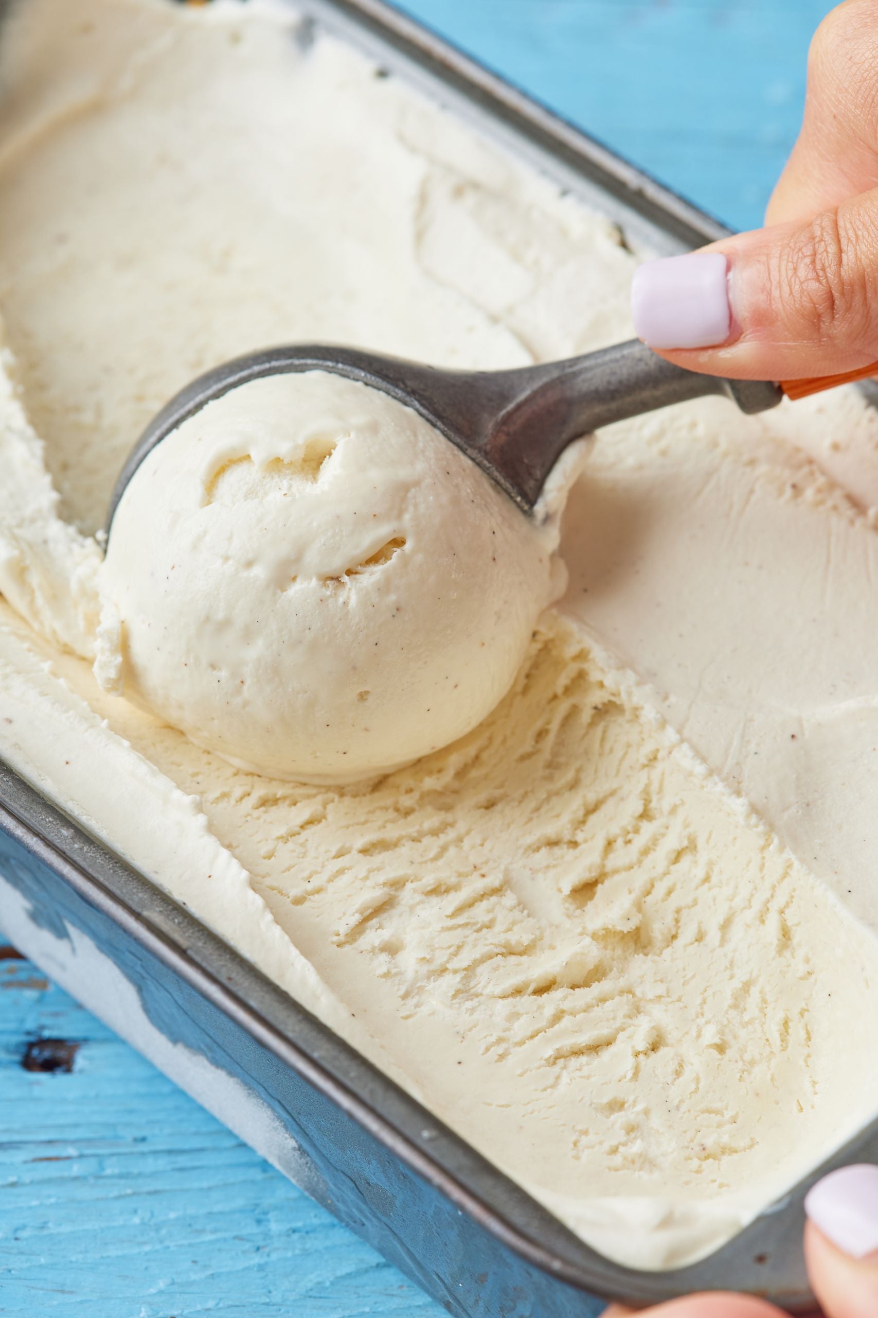 A scoop of creamy vanilla ice cream in the loaf tin
