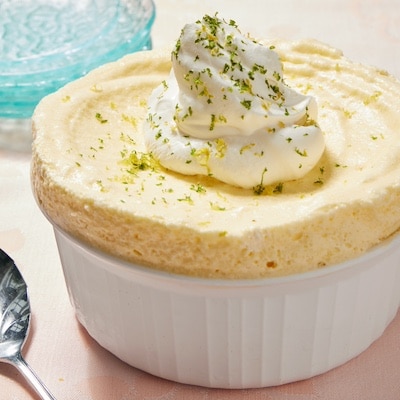 Frozen Lemon Lime Souffle is in bright yellow color, light and refreshing. Topped with whipped cream and lime zest.