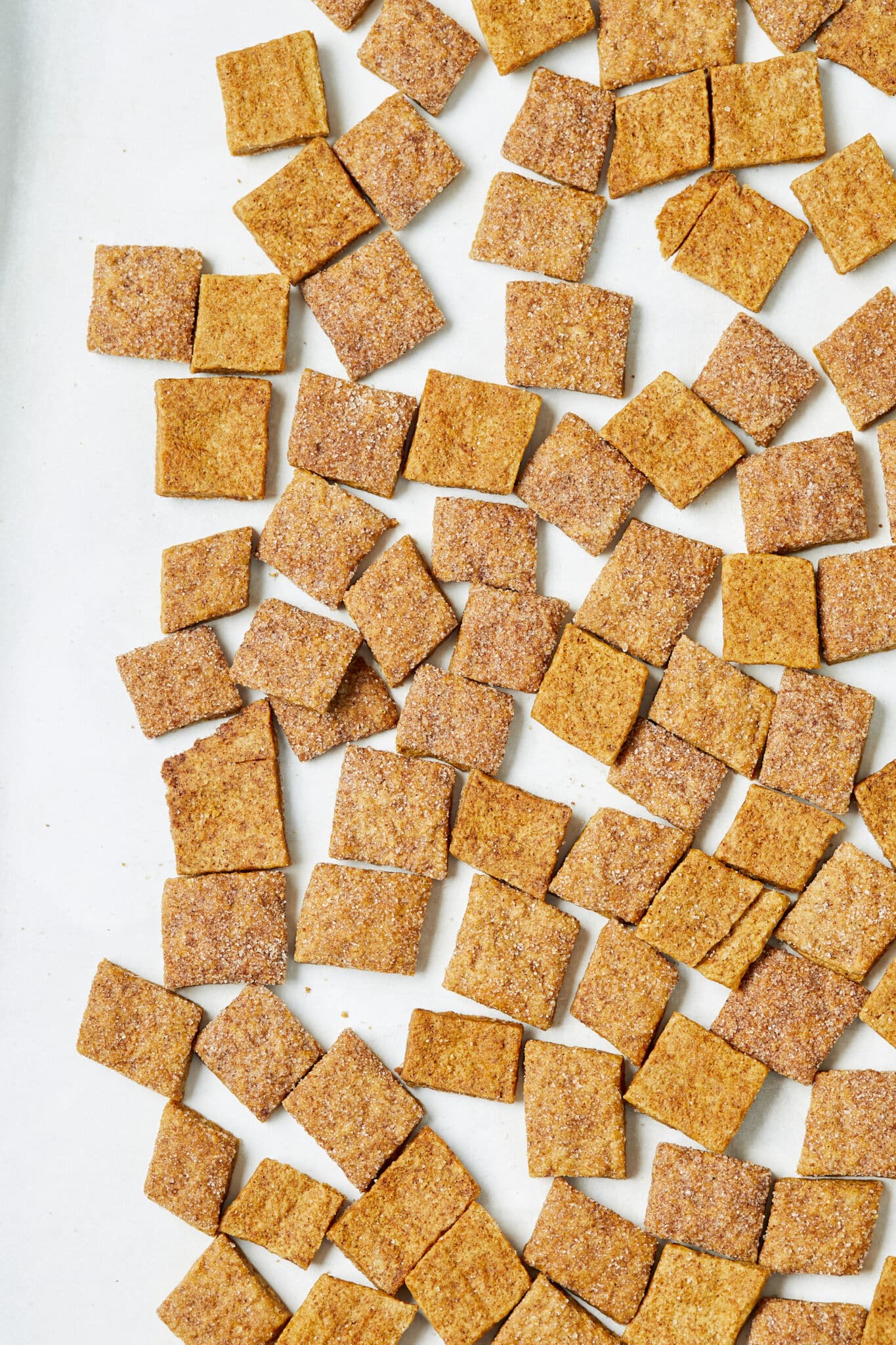 Homemade Cinnamon Toast Crunch is spread out isn one layer. They look miles ahead of store-bought in a perfect bite size and hearty, extra-crispy squares of sweet, warmly-spicy cinnamon flavor.
