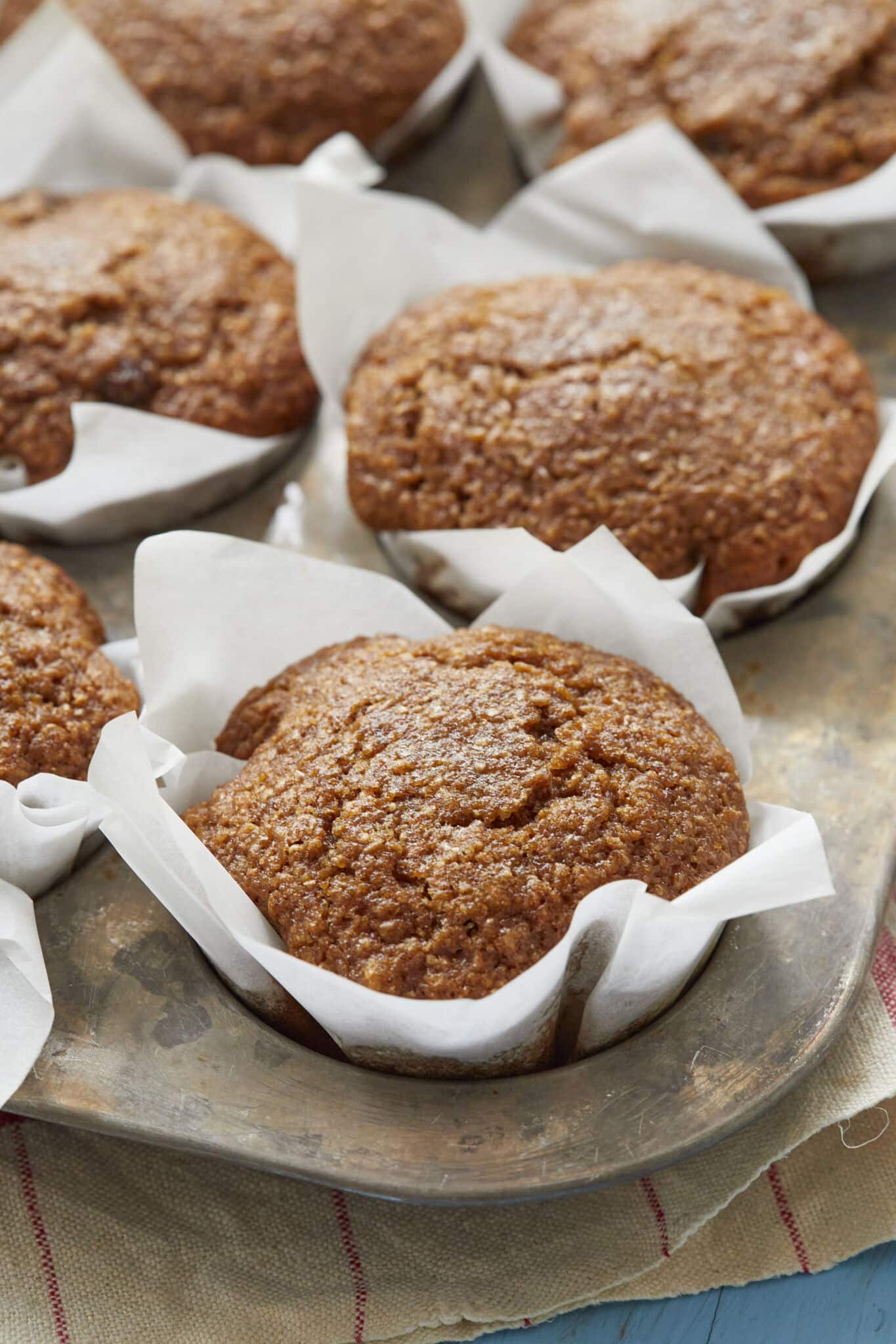 Healthy Bran Muffins are baked perfectly in liners in the muffin tin. They look moist, soft and packed with raisins. 