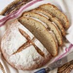 Joululimppu (Finnish Christmas Bread) is a spiced, subtly sweet rye bread and is baked in a round shape scored cross on top. It's dusted tight flour and sliced in a basket lined with a kitchen towel.