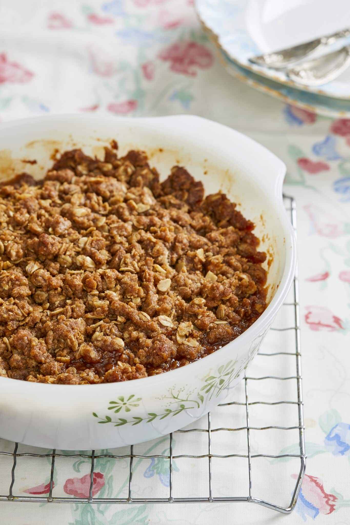 Boozy Whisky Apple Crisp is baked in a milkgalss Pyrex baking dish with sweet, buttery baked apples covered with a cinnamon oatmeal-cinnamon crispy top.