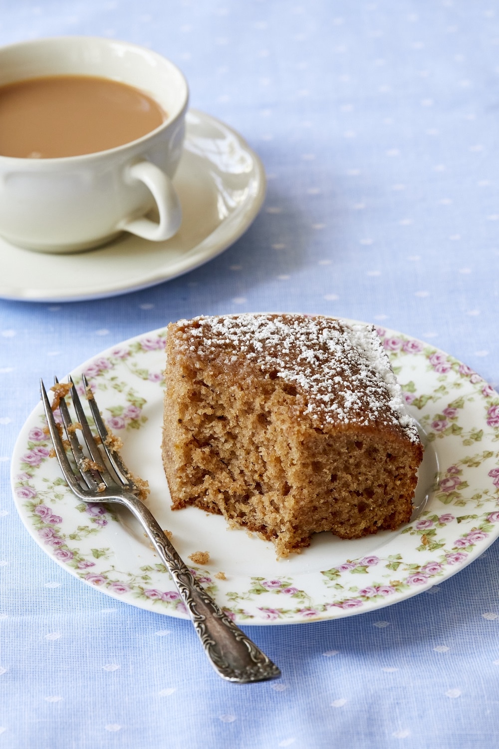 Irish Spice Cake served with tea, with one bite taken. 