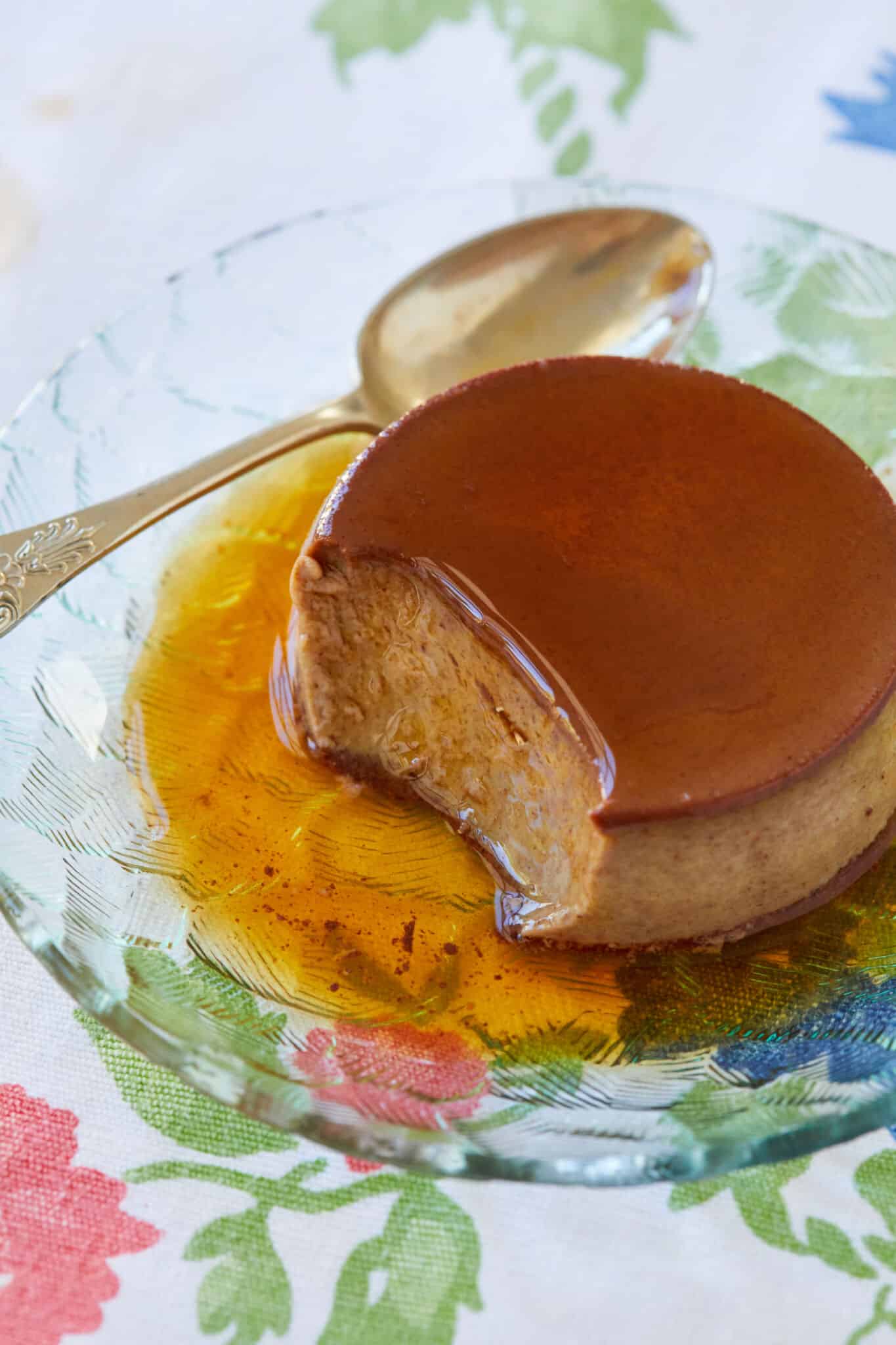 Chocolate Crème Caramel is served on a glass dessert plate, with silky and tender custard topped with decadent sweet caramel. 