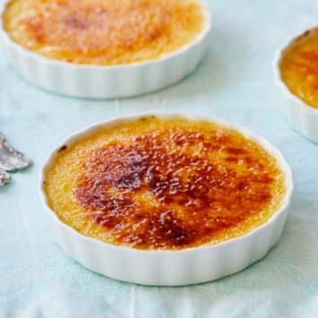 Three dishes of Passionfruit Crème Brûlée is served. Each Passionfruit Crème Brûlée has a rich custard base topped with a layer of amber-color caramelized sugar.