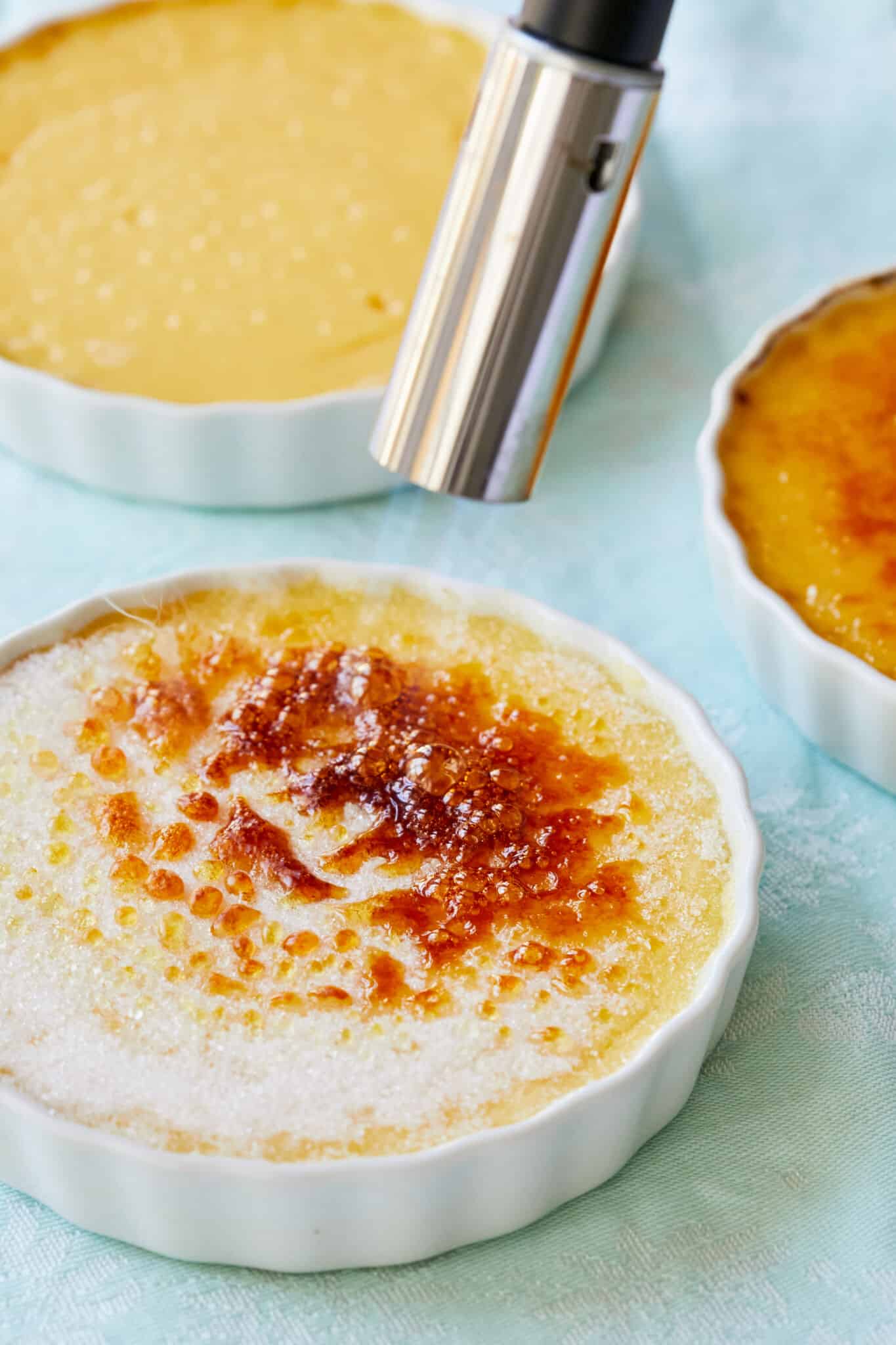Step-by-step instruction on how to make Passion Fruit Crème Brûlée: Using a kitchen torch, caramelize the sugar until brown and bubbly. Let cool for a few minutes before serving.