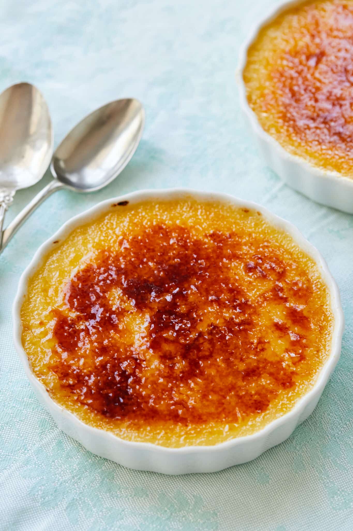 Passionfruit Crème Brûlée has a rich custard base topped with a layer of amber-color caramelized sugar. 