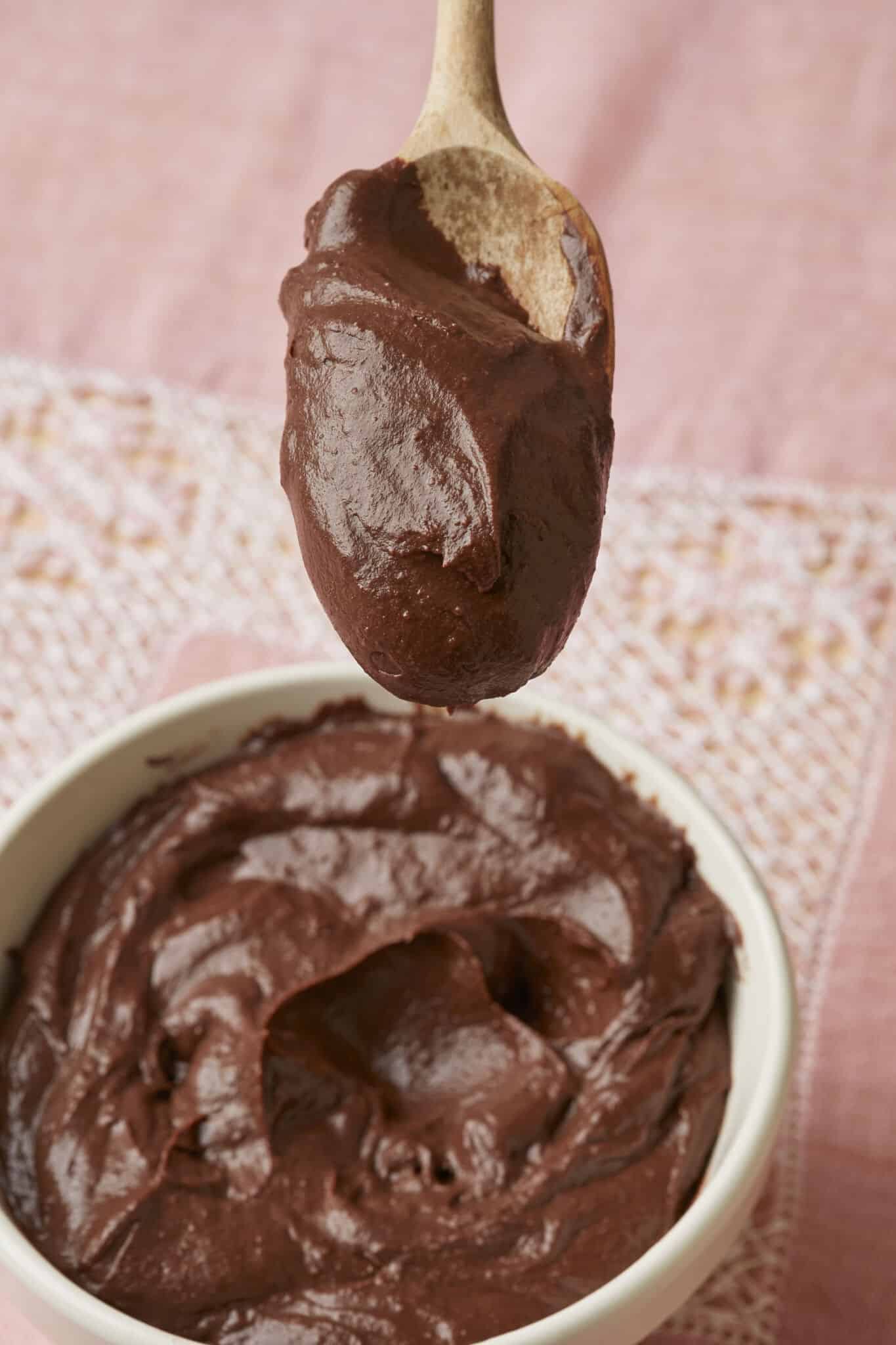 A close-up shot at the being-lifted spoon of Chocolate Pastry Cream shows its gloss and thickness. 