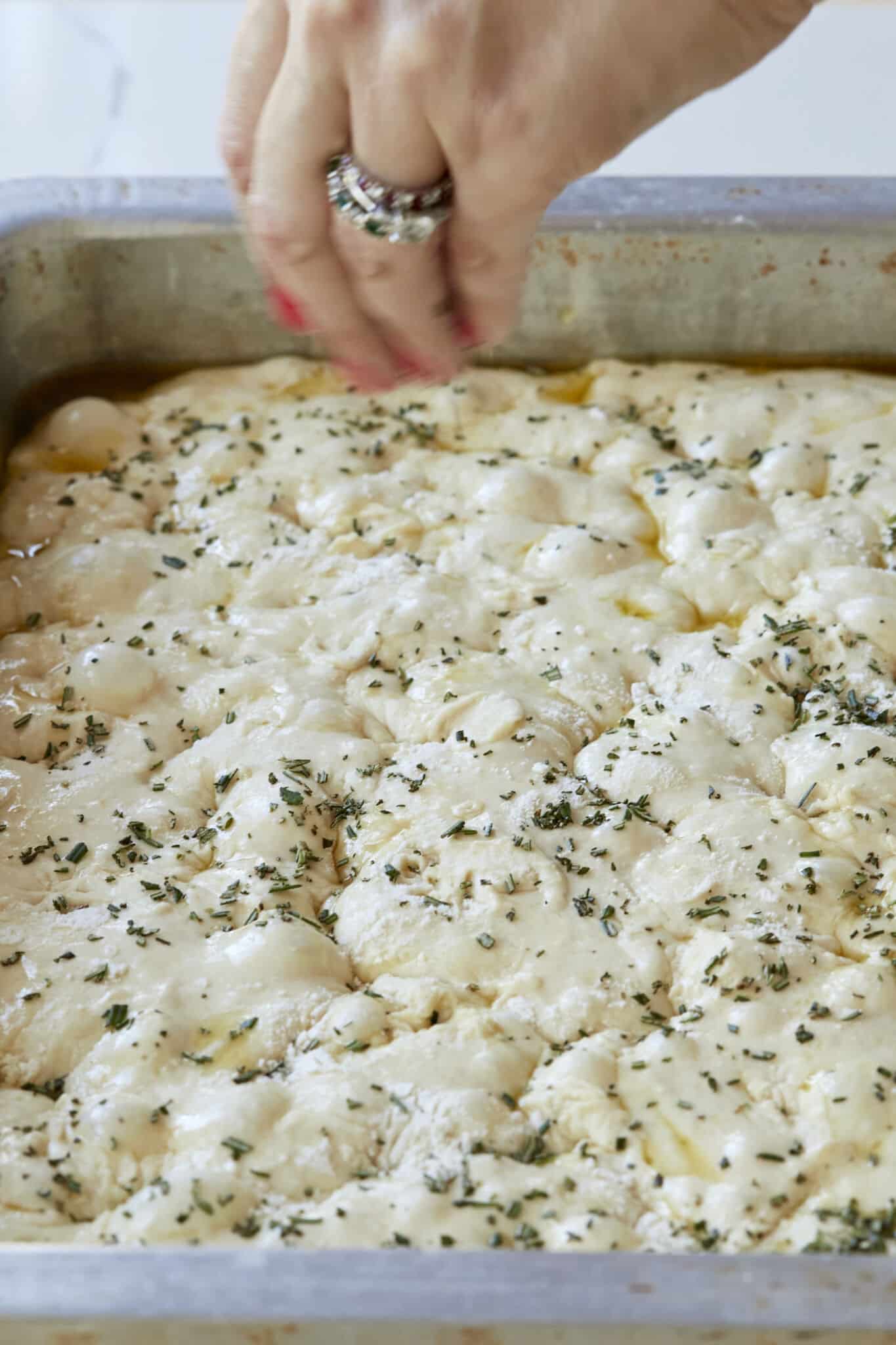 Drizzle the dough with the remaining 2 tablespoons of olive oil and top with chopped rosemary.