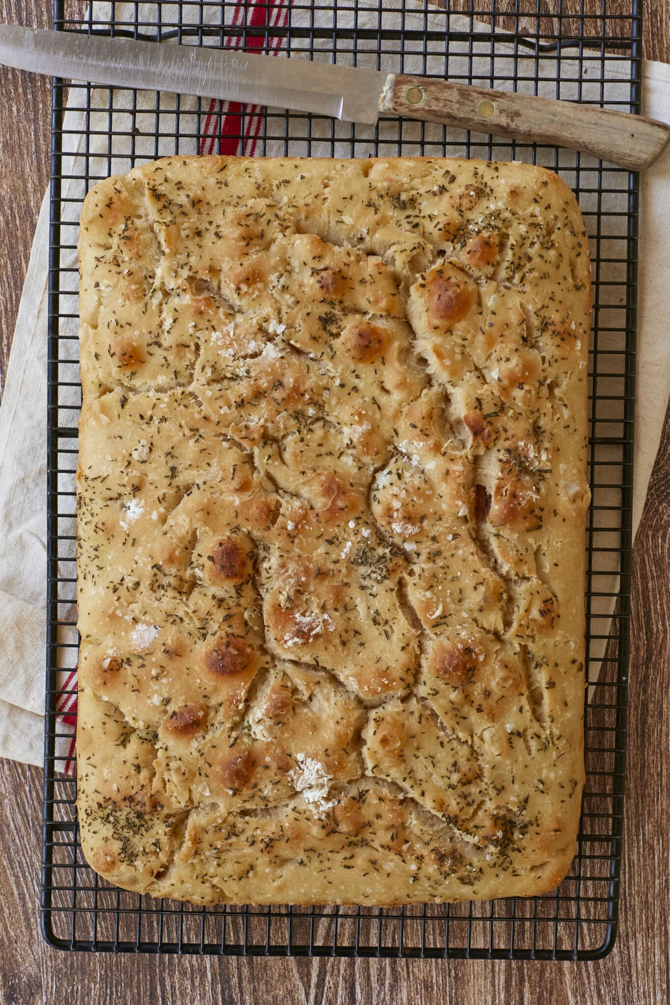 No-Knead Focaccia is golden, bubbly and crispy, loaded with flaky sea salt, Roasted Garlic and Rosemary. 