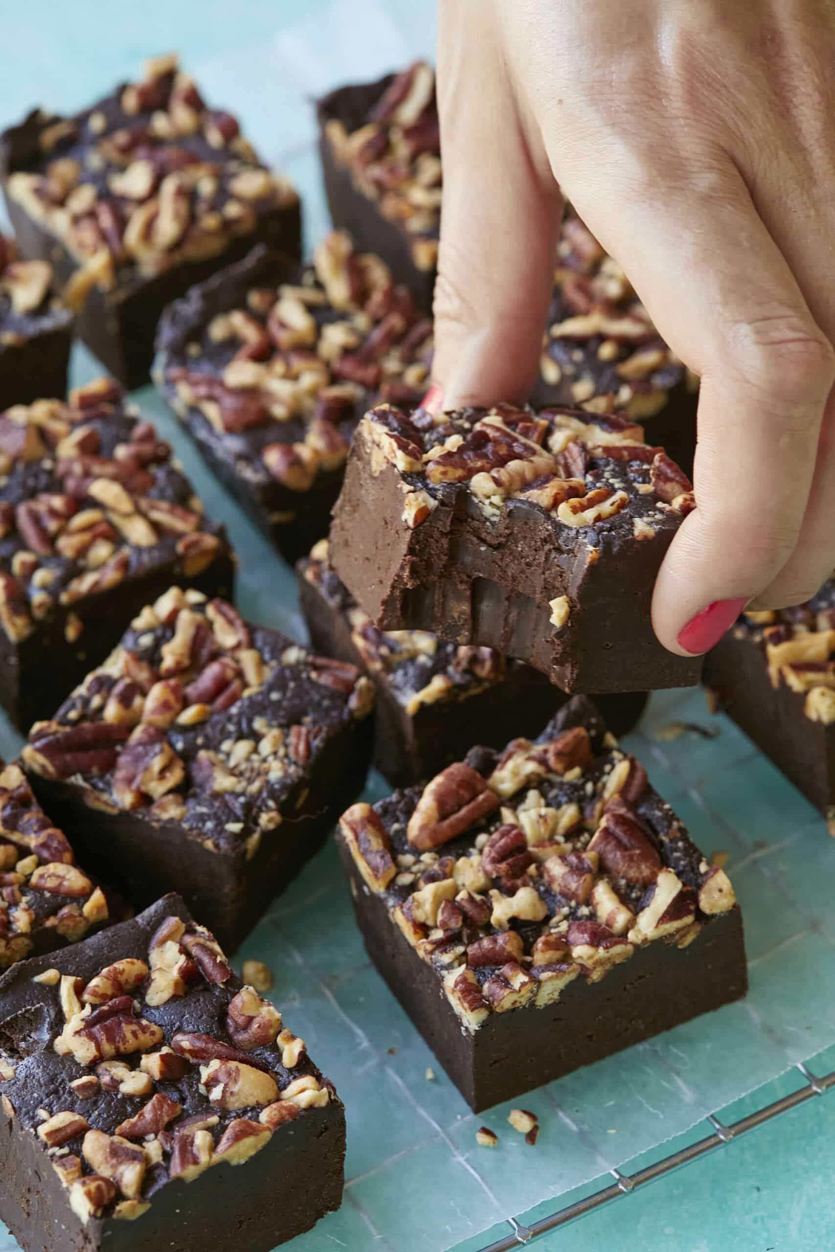 A close up shot at a piece of Whiskey fudge with a bite taken.