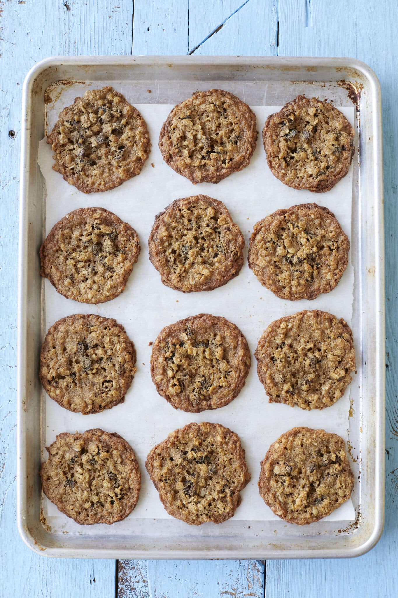 A baking tray of Almond Flour Cinnamon Raisin Cookies with golden brown colors and chewy, crispy edges. 