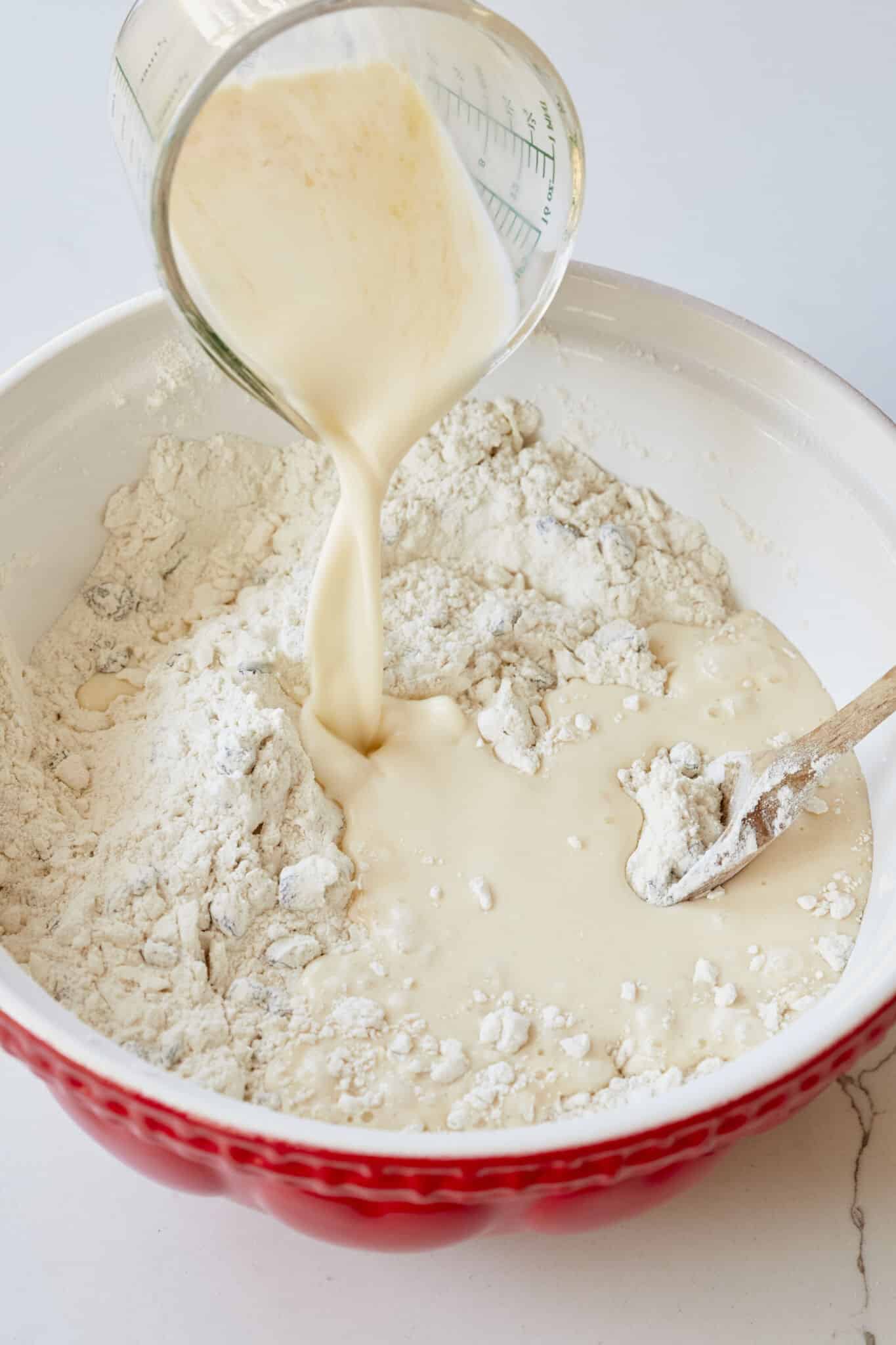 Step-by-step instructions on how to make Best-Ever Irish Scones: pouring the wet mixture into the dry mixture gradually. 