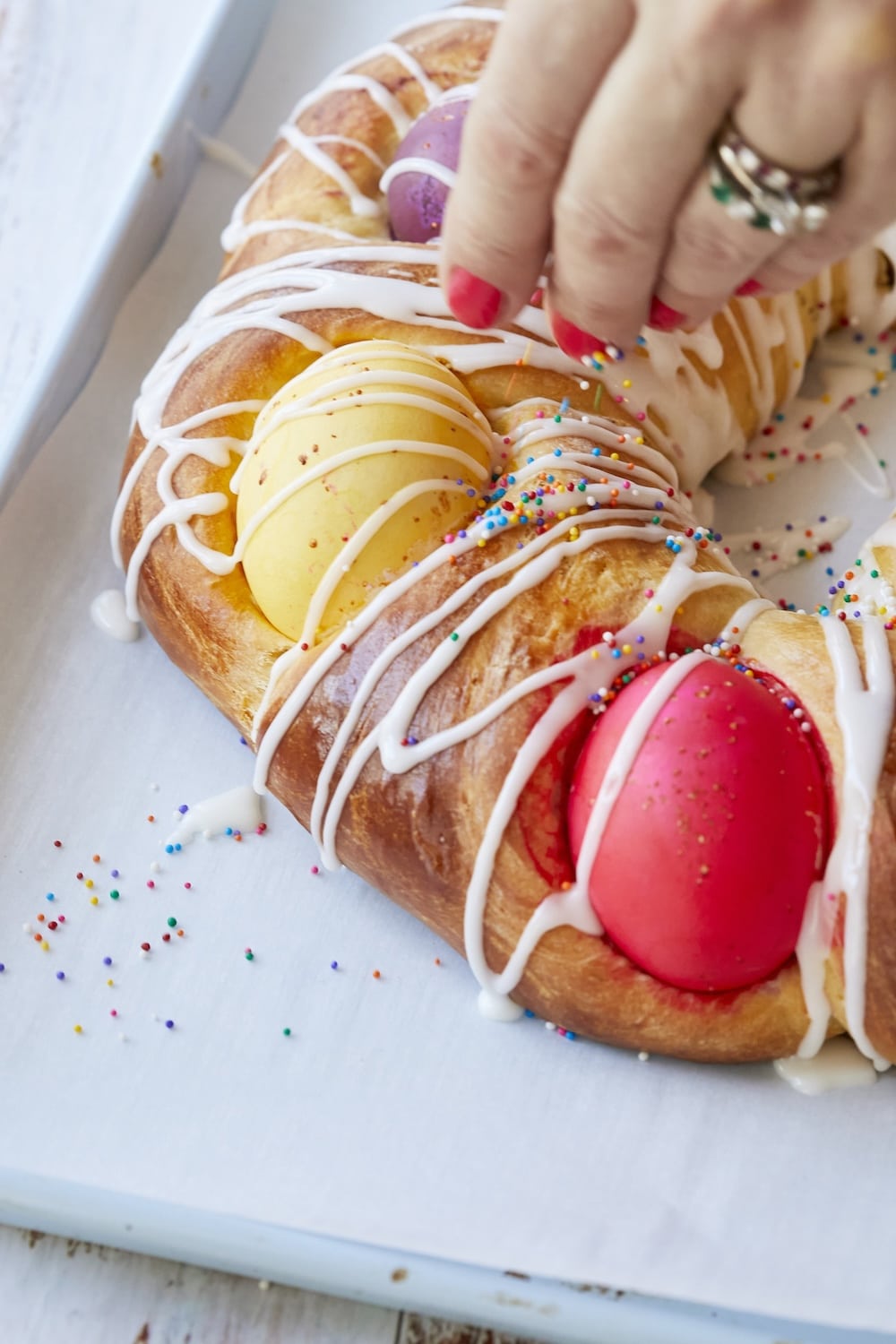 Adding sprinkles onto the bread.