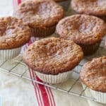 Healthy Almond Flour Muffins with applesauce are baked until golden brown, cooling on the rack.