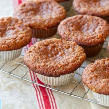 Healthy Almond Flour Muffins with applesauce are baked until golden brown, cooling on the rack.