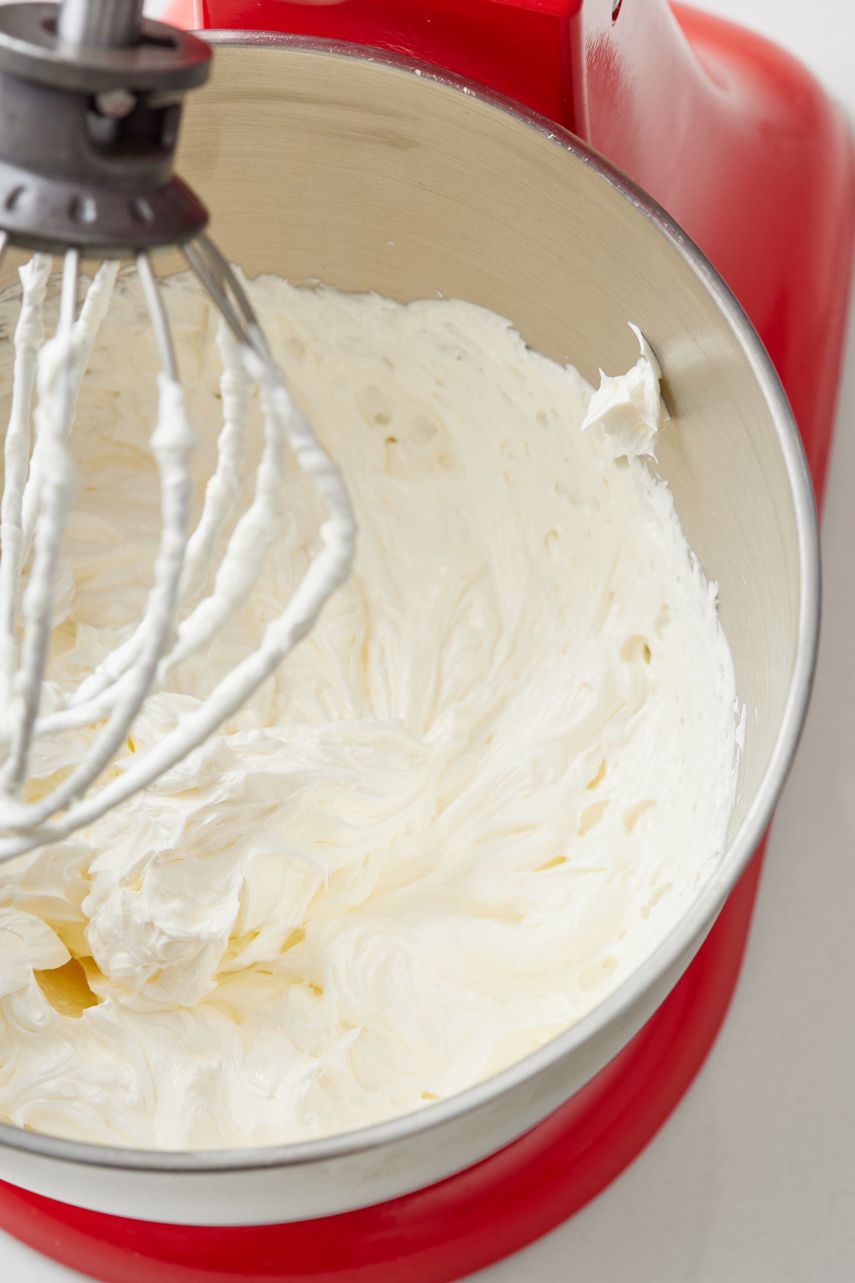 Step-by-step instructions on how to make salted caramel frosting: cream butter and sugar until light and fluffy.
