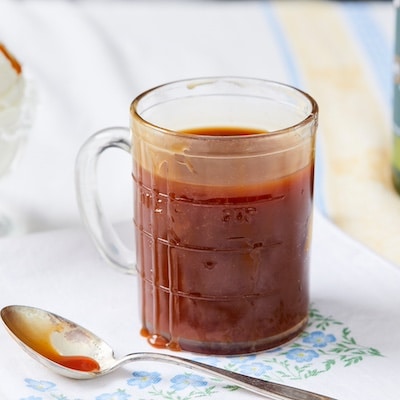 A glass mug of deep amber color Irish Whiskey Caramel sauce.
