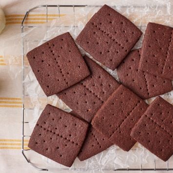 Chocolate Graham crackers o the cooling rack, served with milk .