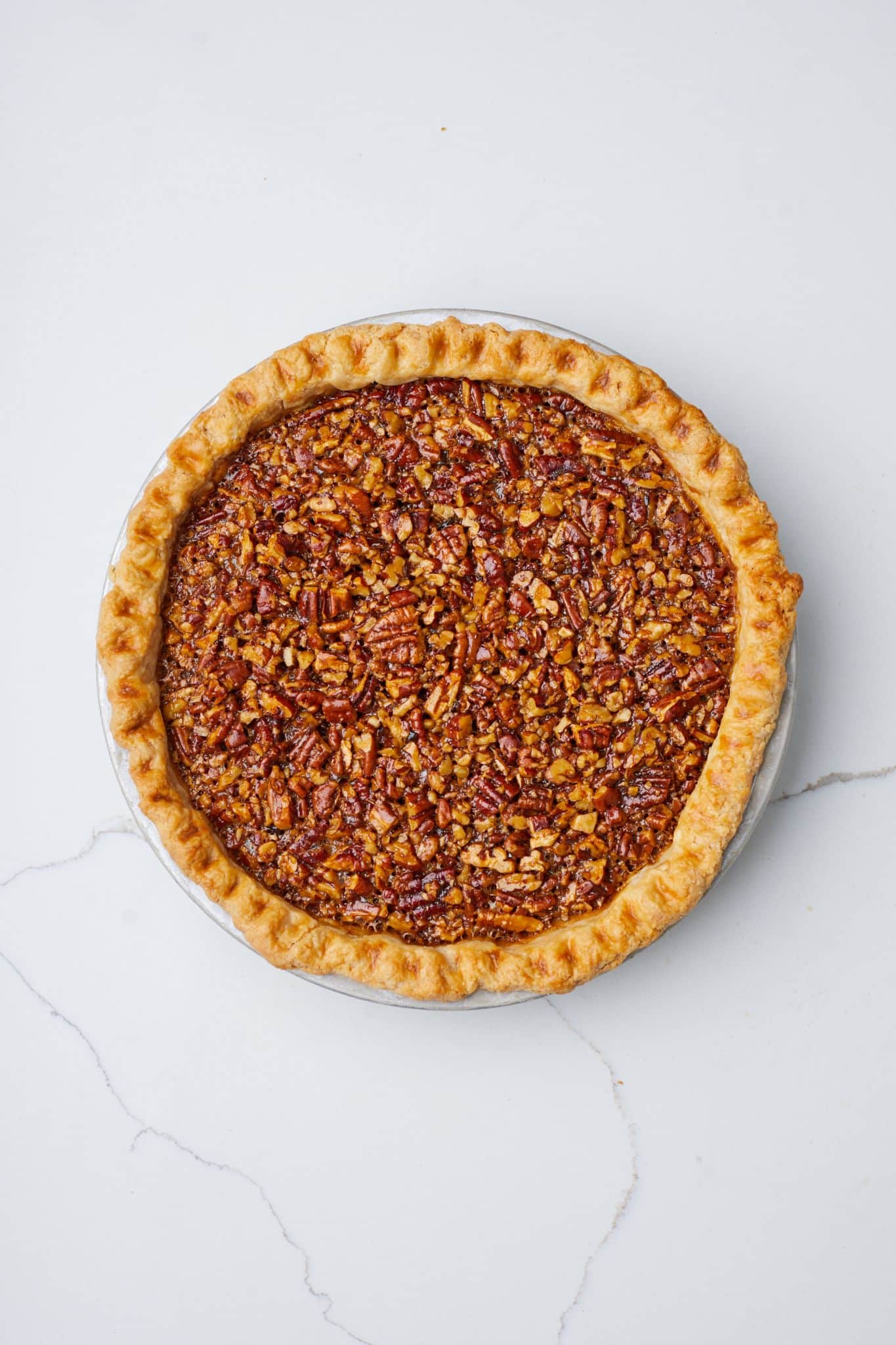 Bake the Caramel Pecan Pie until the filling sets and the crust is golden. 