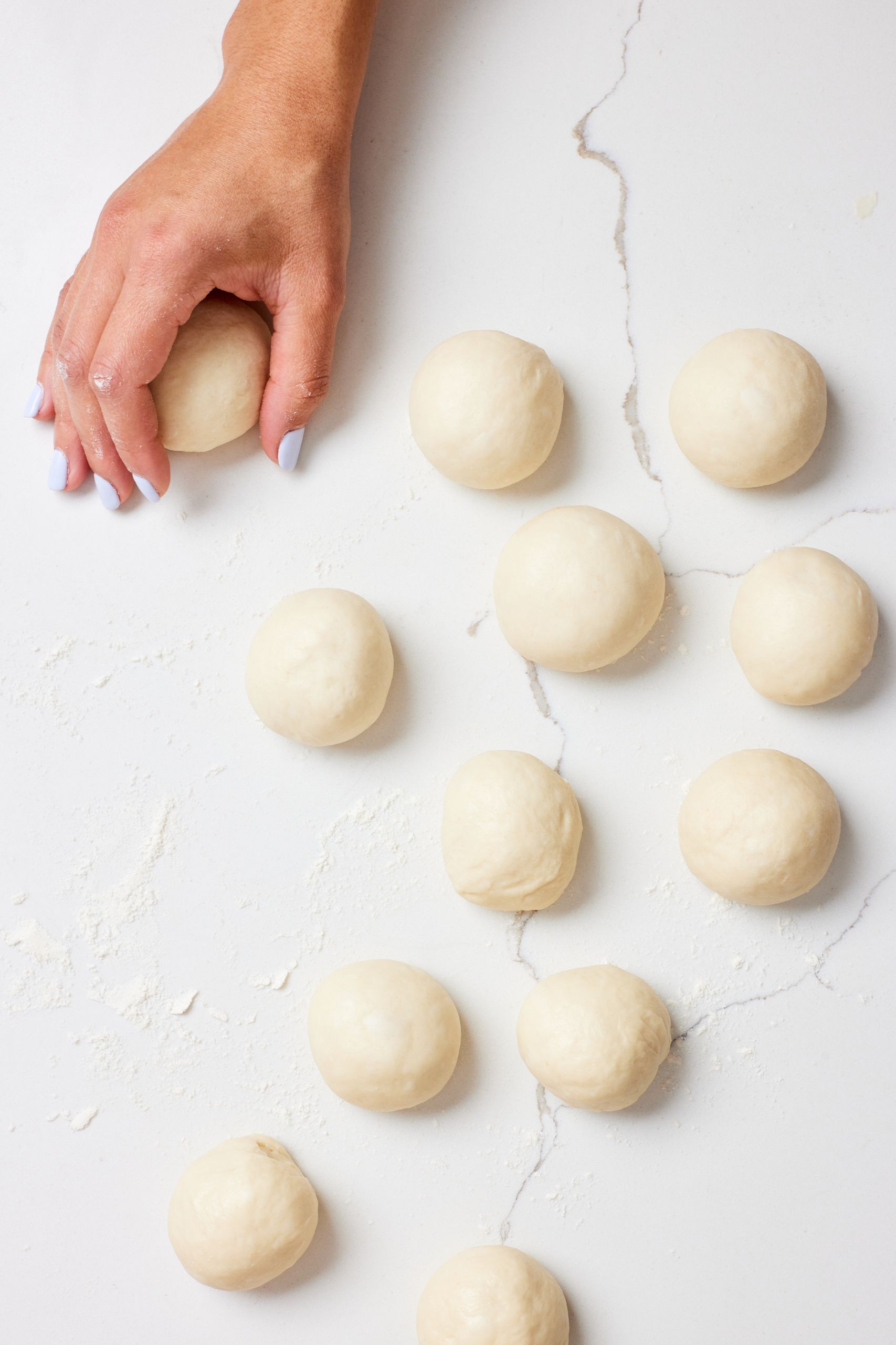 Shape the dough: divide it into 12 equal portions and roll each into a ball. 